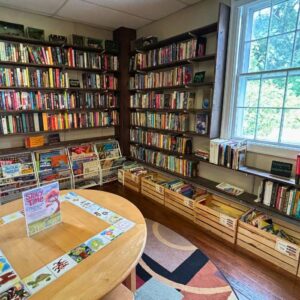 Shelves of gently used books in the Welcome Center & Curiosity Shop.
